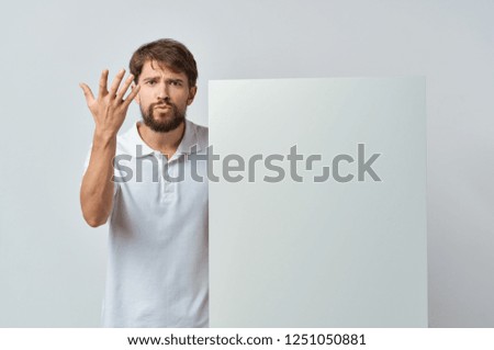 A man gesticulates with a white mockup                    