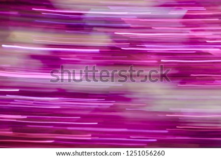 Abstract pink shining tinsel garland with low speed shutter