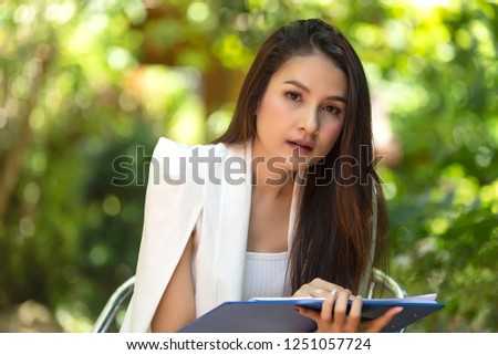 Beautiful business woman sit and work in the garden,