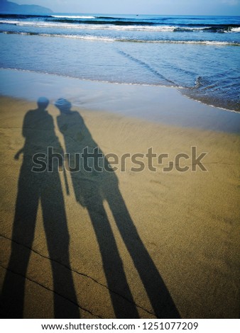 man shadows on the beach