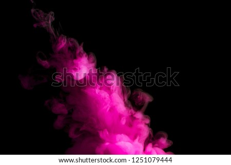 paint stream in water, lilac colored ink cloud on black background, abstract background