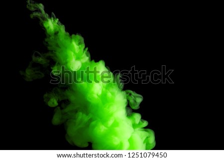 paint stream in water, green colored ink cloud on black background, abstract background