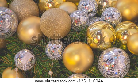 Golden and silver shiny glittering decoration Christmas bauble ball on Christmas tree.