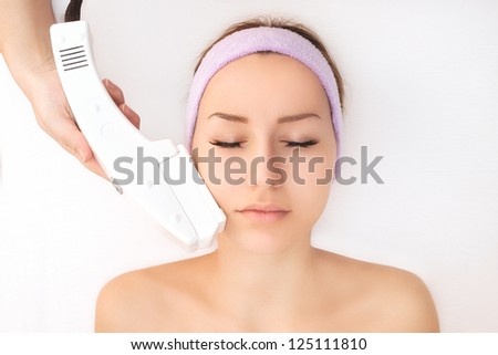 Young woman receiving laser treatment Royalty-Free Stock Photo #125111810