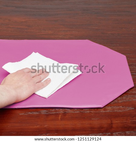 Cleaning Octagon Shaped Pink Kitchen Place Mat on Wood Surface