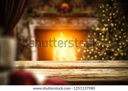 Desk of free space in home interior with fireplace and christmas tree 