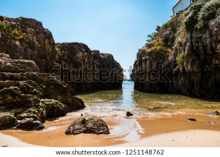The Praia da Rainha (Queen's beach) in Cascais. Paradise between cliffs surrounded by the Atlantic Ocean in Cascais, district of Lisbon, Portugal. Royalty-Free Stock Photo #1251148762