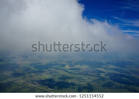 View from under the clouds. I touch the clouds. Cloud base. Flying over the fields and meadows.