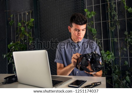 Young photographer reviewing photos on camera