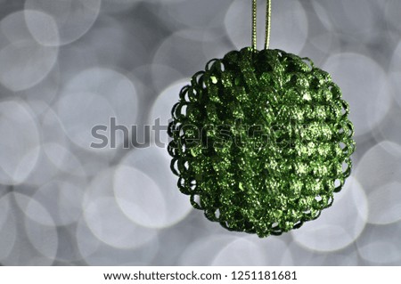 Elegant colored New Year and Christmas ball on the background with light effect and bokeh.Green,white,silver