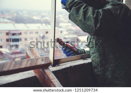 man worker welding of steel in window