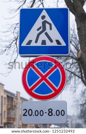 car traffic signs. Two road signs hang over the road.