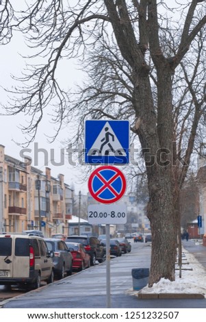 car traffic signs. Two road signs hang over the road.
