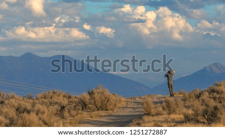 Man on a road overlooking Utah Valley on sunny day
