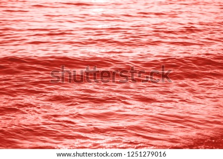 Sea waves background in living coral color. Pantone color of the year 2019 demonstration.
