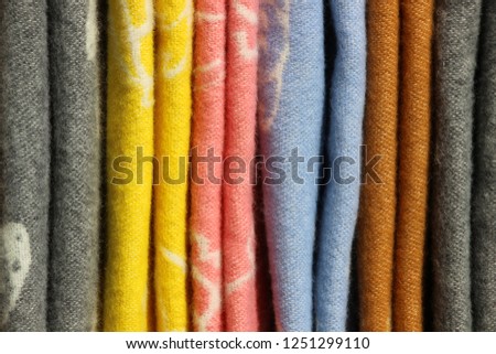 Warm wool products. Multicolored fabrics, real store shelf, vintage selective background.
