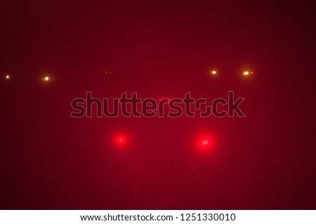 Red stop car lights in thick fog