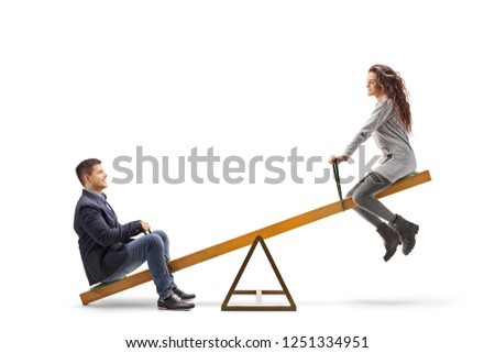Young man and woman playing on a seesaw isolated on white background Royalty-Free Stock Photo #1251334951