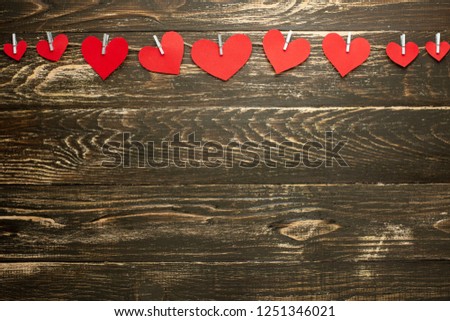 Gingham Love Valentine's Hearts natural cord and red hearts with a rustic snag texture background, copy space, layout for design, banner.