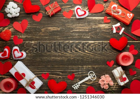 love, texture with red hearts, candles, gifts for lovers on a wooden background. Valentine's Day. Flat-lay, top view, copy space.
