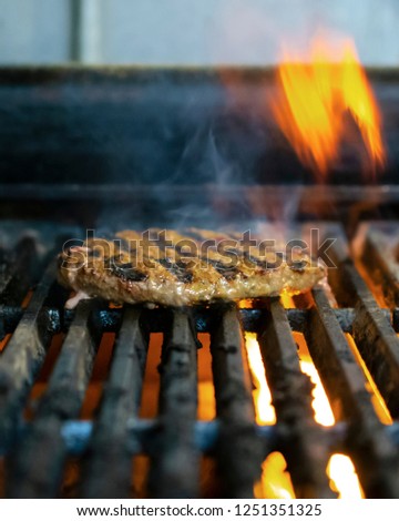 Beef Burger on the grill in a commercial kitchen restaurant