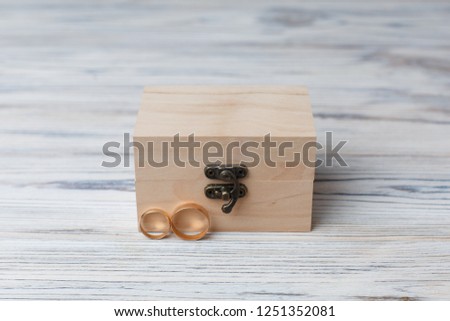two golden wedding rings in wooden box with copy space for text close up. wedding rings isolated  on wooden background. wedding day. wedding details. love story concept. 