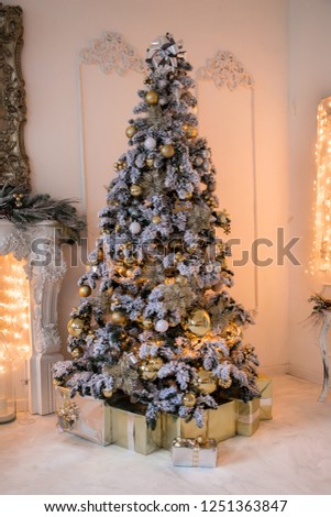 Christmas interior background with New Year Tree decorated for holiday and present boxes