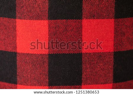 Plaid flannel material laid out and shot up close