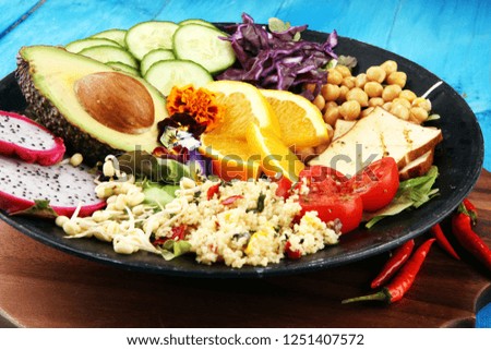 grilled tofu and dragon fruit buddha bowl with vegetable and humus.
