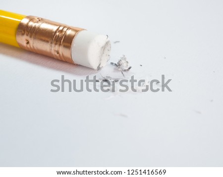 pencil eraser and eraser scrap on white paper texture background.