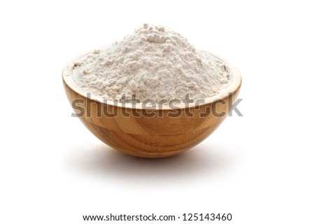 wheat flour in wooden bow Royalty-Free Stock Photo #125143460