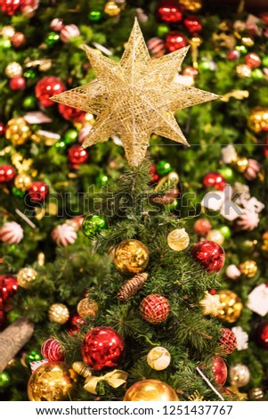 Christmas tree  decorated with colorful balls and golden star	