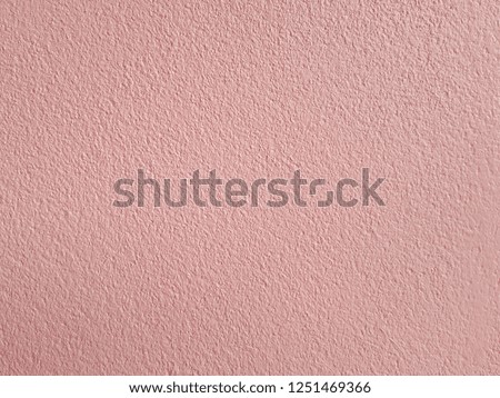 Pink background with patterned concrete.