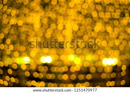 Abstract blur gold light bokeh with black background.