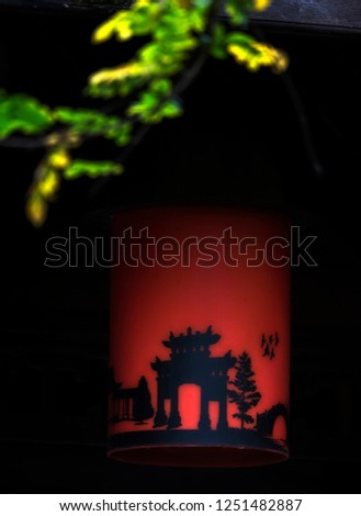 shadow of a Chinese temple on a traditional red wall