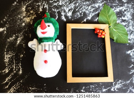 Snowman and snowfall  on christmas day with copy space for message