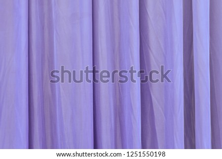 Beautiful and original texture. Complex, incomprehensible, original and interesting texture, pattern and background of vertical beautiful curtains of chemical and polymer fabric.