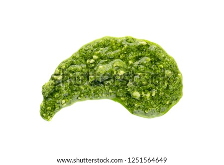Pesto spread or blob isolated on white background. Green italian homemade spilled sauce made of ground basil, garlic, pine seeds, olives and pecorino sardo cheese top view Royalty-Free Stock Photo #1251564649
