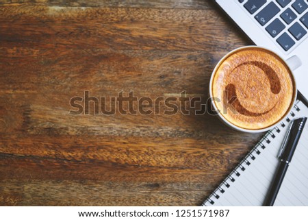Coffee mug with Loading spinner web icon, laptop, notepad and pen on rustic table