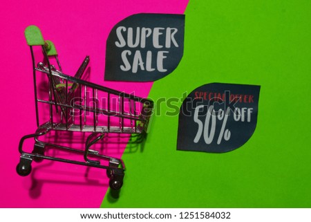 Super Sale and Special Offer 50% Off Text and Shopping cart. Discount and promotion business concept on colorful background