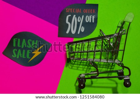 Flash Sale Special Offer 50% Off Shop Now Text and Shopping cart. Discount and promotion business concept on colorful background