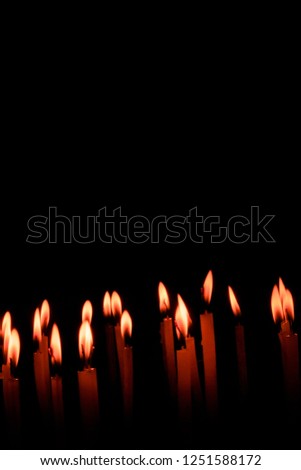 Candle spreading light isolated on black background. Horizontal. Copy Space