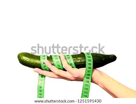 whole healthy cucumber with tape measure stock photo
