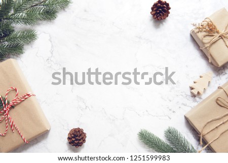 Christmas background with decorations and gift boxes on white marble.