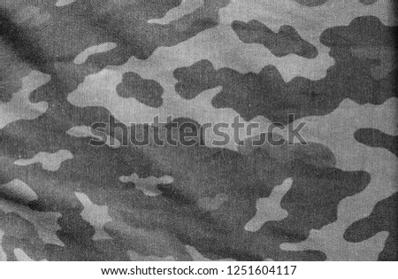 Old camouflage cloth in black and white. Abstract background and texture for design abd ideas.