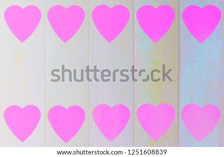 frame of paper pink hearts on wooden retro grunge background with copy space, top view flat lay