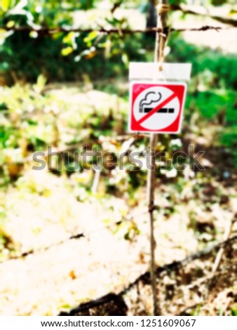 Blur no smoke sign. Blur no smoking sign at the garden. No smoke at the green background.