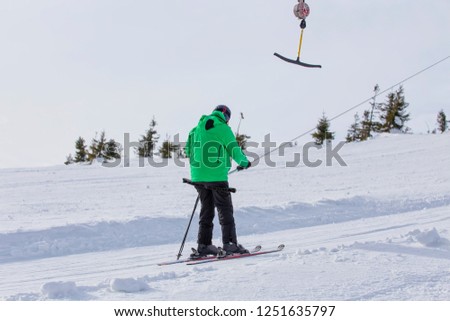 Ski lift on a background of snow-capped mountains