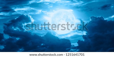 Night sky with blue moon in the clouds "Elements of this image furnished by NASA