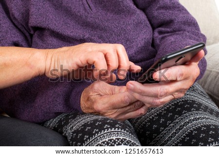 Picture of a senior woman hand using a smartphone